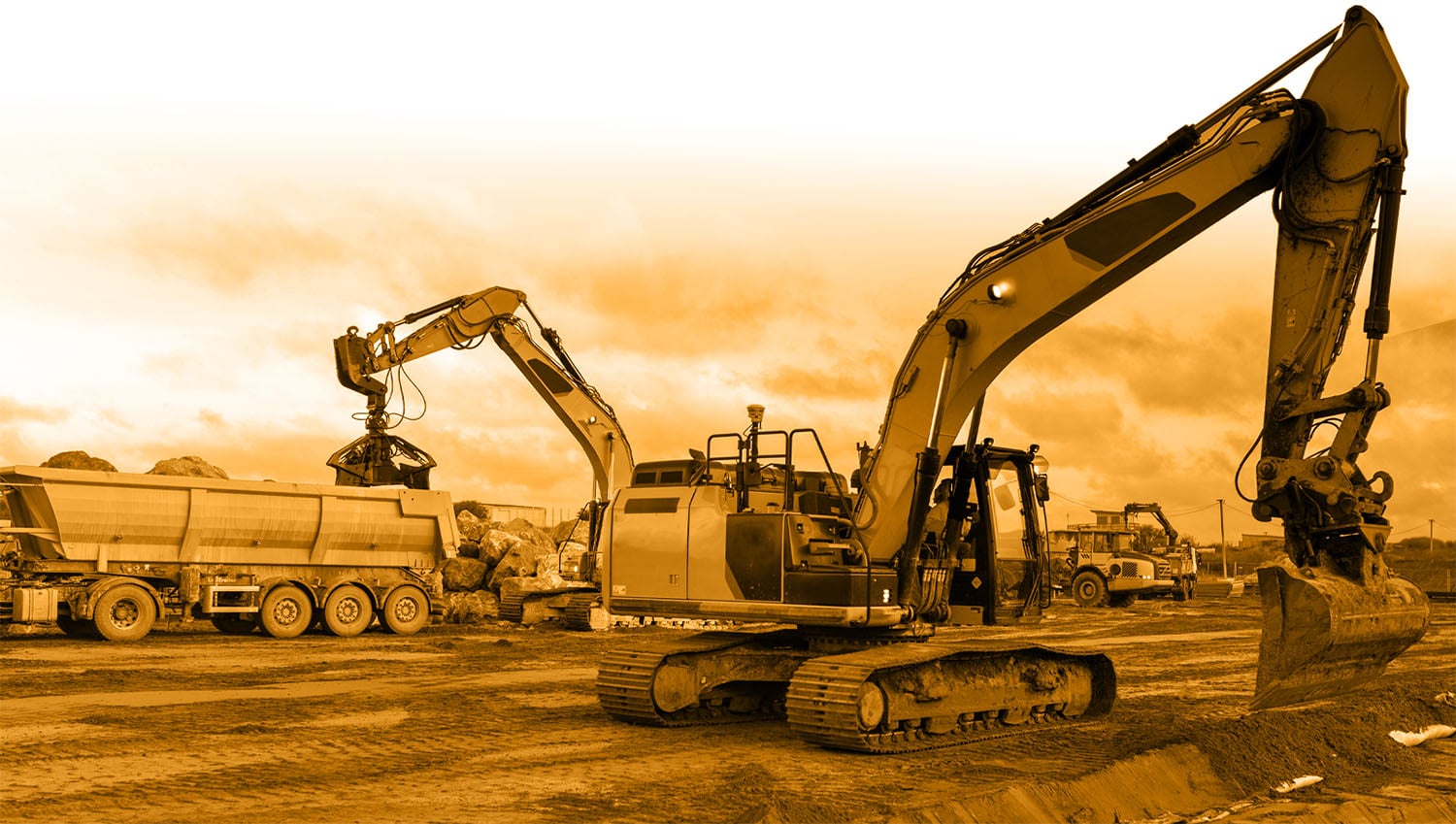 Excavator moving scrap into a trailer